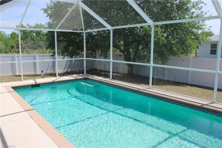 View of swimming pool featuring a lanai, a fenced backyard, and a fenced in pool
