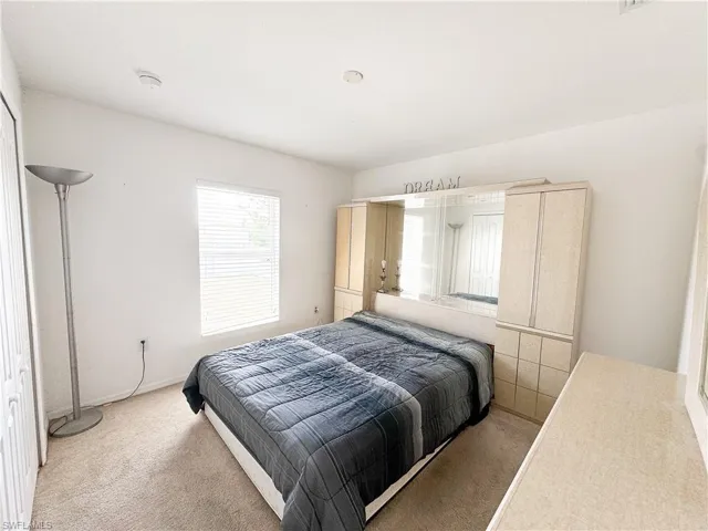 Bedroom featuring light colored carpet