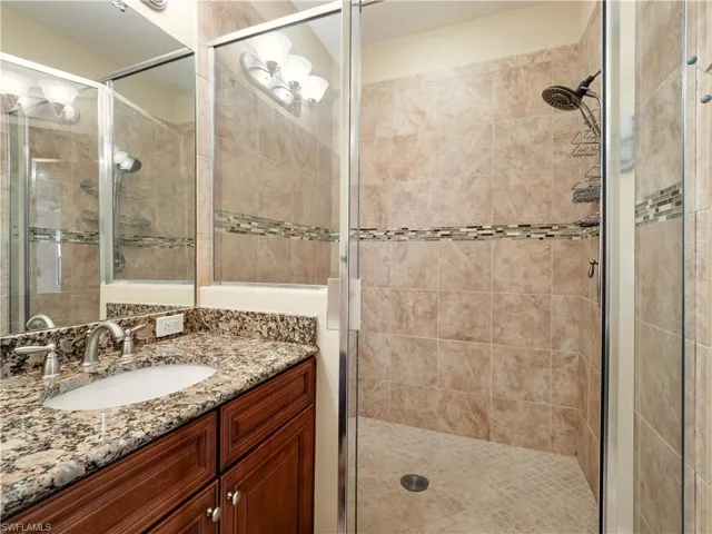 Bathroom with an enclosed shower and vanity
