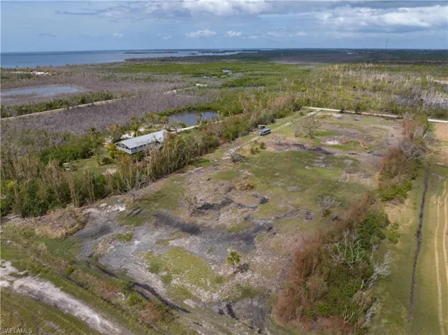 Aerial view of property's location featuring a nearby body of water