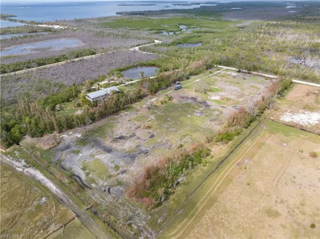 Aerial view of property and surrounding area featuring a large body of water