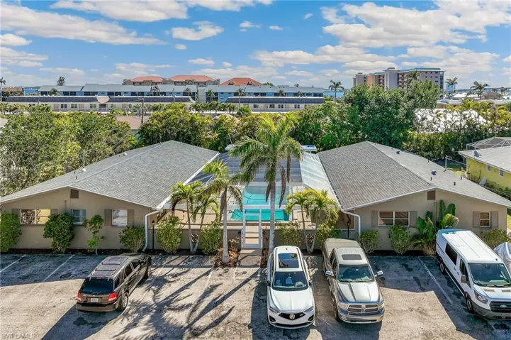 Drone / aerial view featuring a front elevation/parking area view