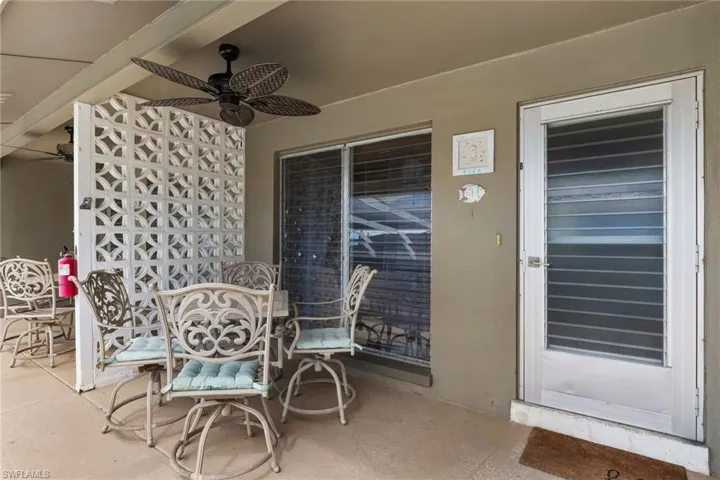 Boca Unit view of patio with outdoor dining space and a ceiling fan,