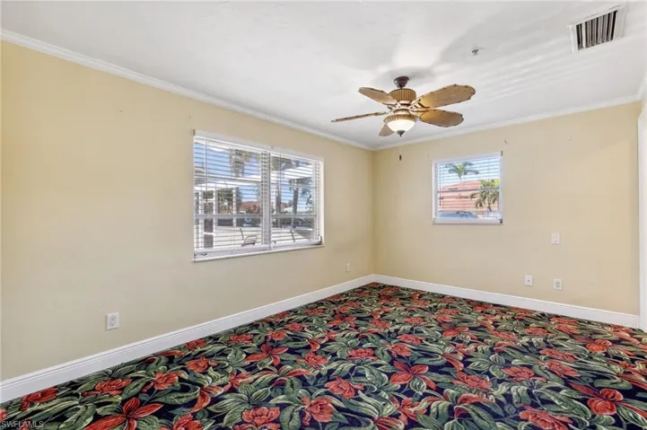The Aruba unit Primary Bedroom with ensuite bath, carpet flooring, closet, and ceiling fan