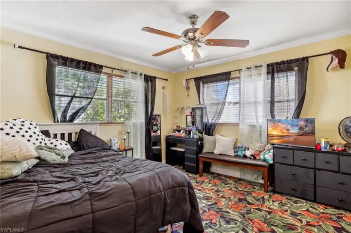 The Boca unit bedroom featuring a ceiling fan, and carpet flooring