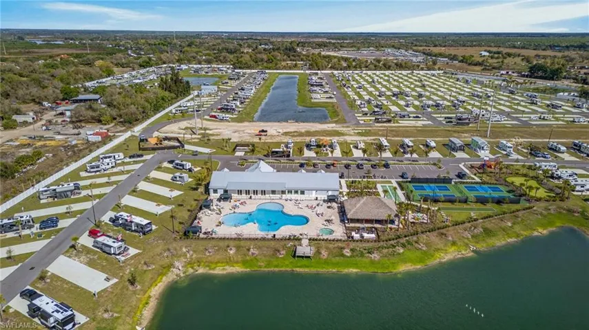 Aerial view of property and surrounding area featuring a large body of water