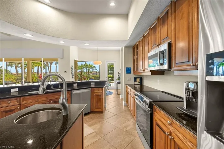 Stainless-Steel Appliances with additional island in center of kitchen