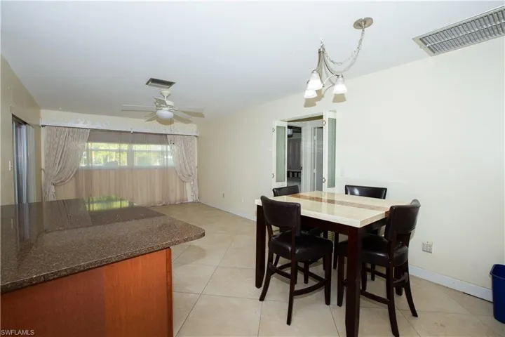 Dining area with baseboards, visible vents, and ceiling fan