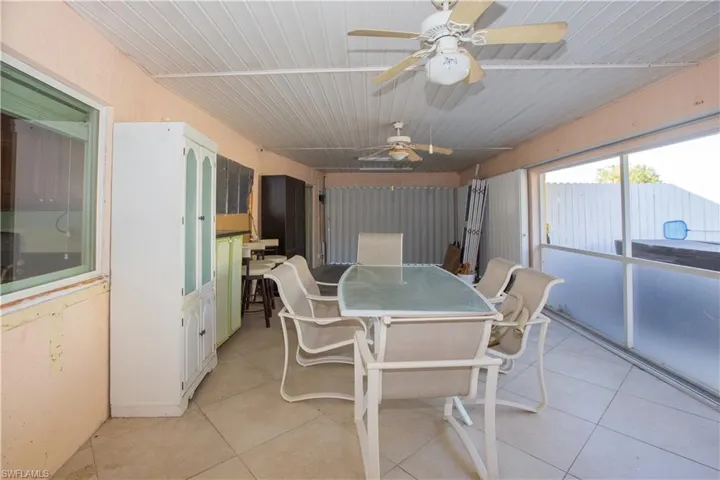 Sun room with outdoor dining area and ceiling fan