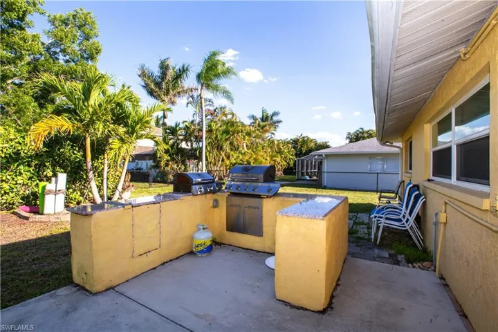 View of patio featuring a grill, exterior kitchen, and fence