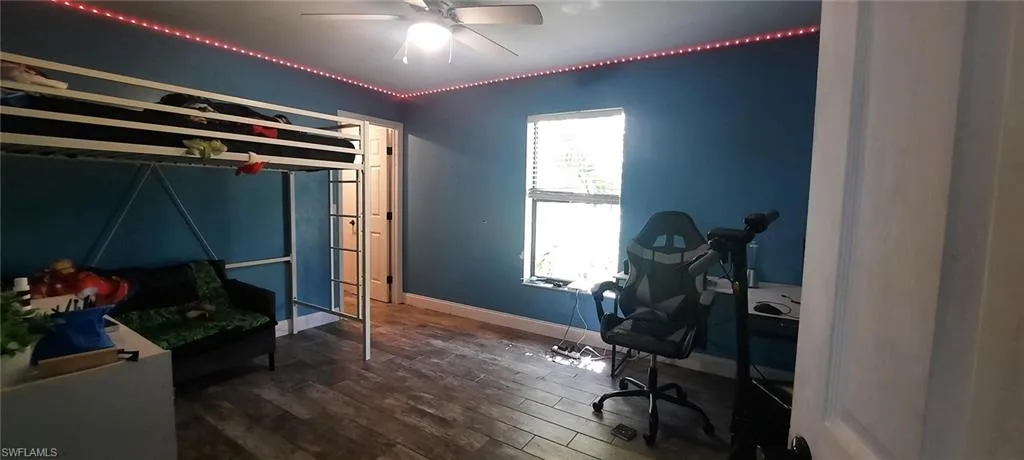 Bedroom featuring ceiling fan, baseboards, and tile floors