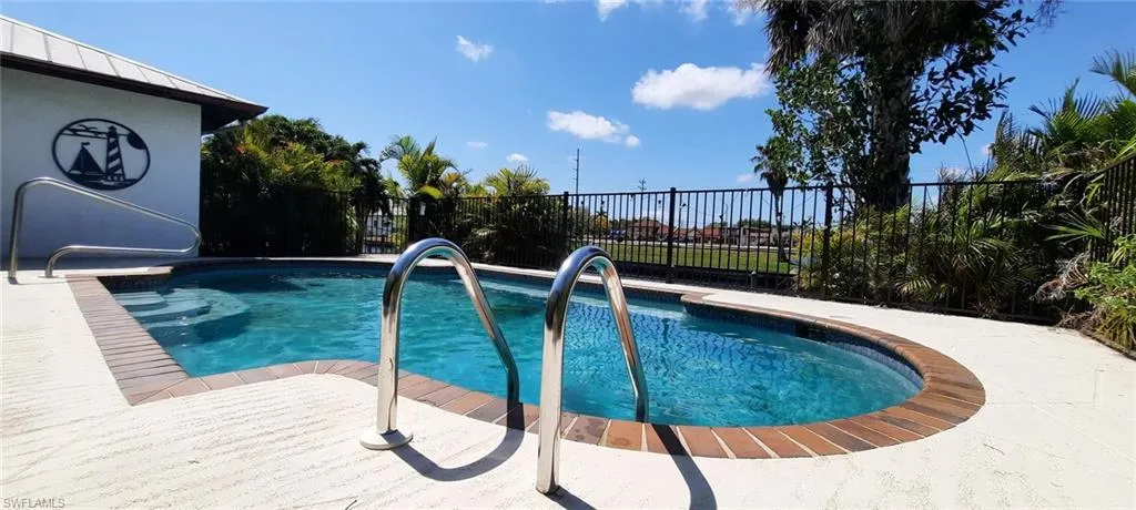 View of swimming pool with fence and a fenced in pool