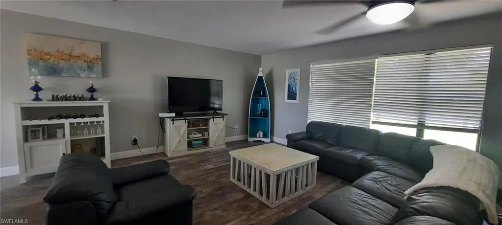 Living room with tile flooring and baseboards