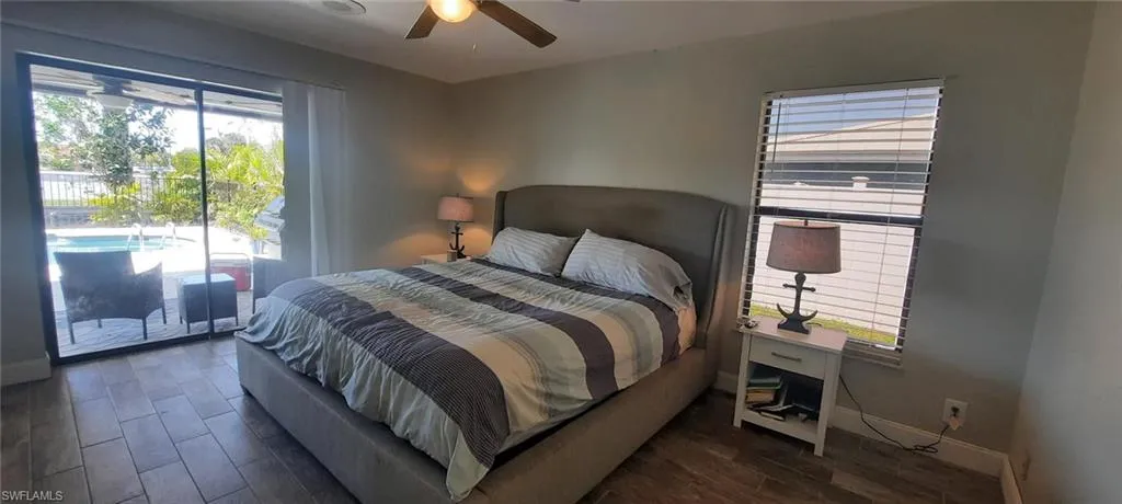 Bedroom with ceiling fan, tile floors, access to exterior, and baseboards