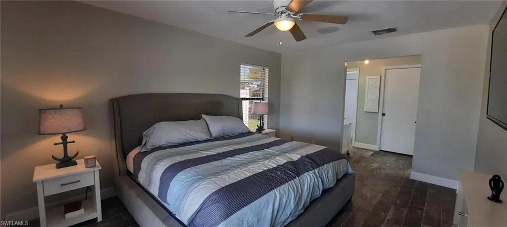 Bedroom featuring baseboards, visible vents, tile floors, and a ceiling fan