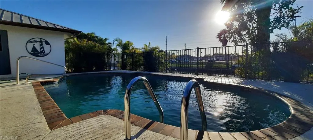 View of pool with a fenced in pool and fence