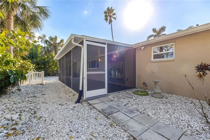 Rear view of house featuring a sunroom