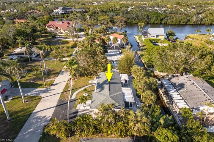 Birds eye view of property with a water view