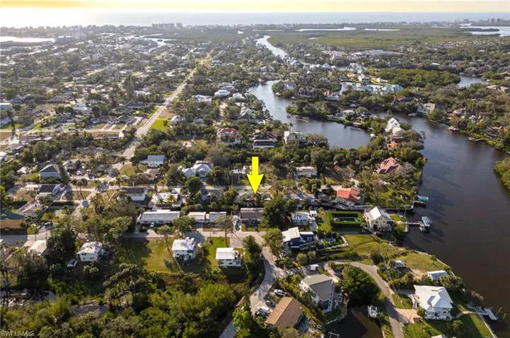 Birds eye view of property with a water view