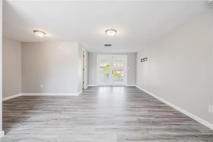 Unfurnished room featuring light hardwood / wood-style flooring and french doors