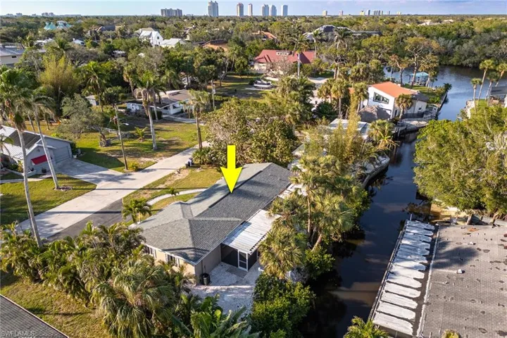Birds eye view of property with a water view