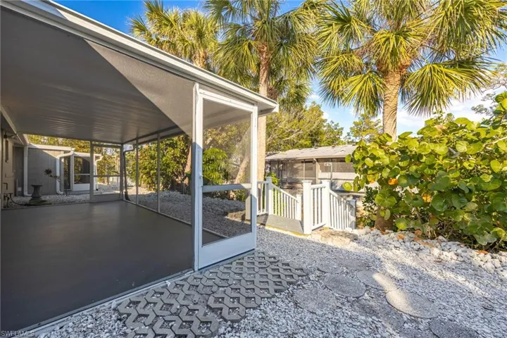 View of patio with a sunroom