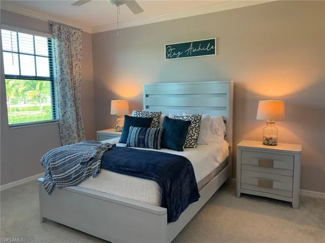 Master bedroom featuring ceiling fan and ornamental molding