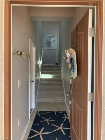 Hallway featuring light tile patterned flooring