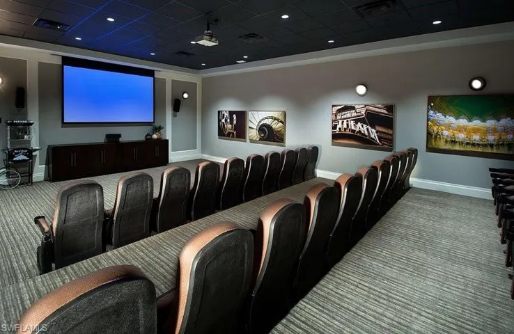 Community theater room with a paneled ceiling and carpet floors