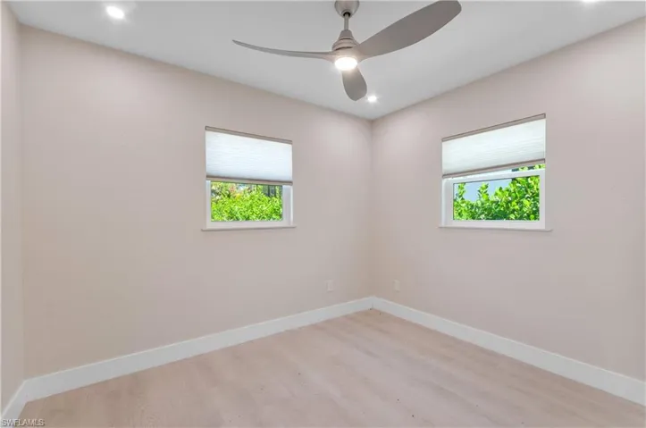 bedroom #1 with a ceiling fan, wood finished floors, and recessed lighting