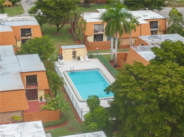 Community pool featuring a patio and an outbuilding