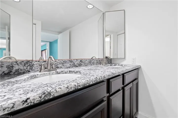 Bathroom featuring double vanity and recessed lighting