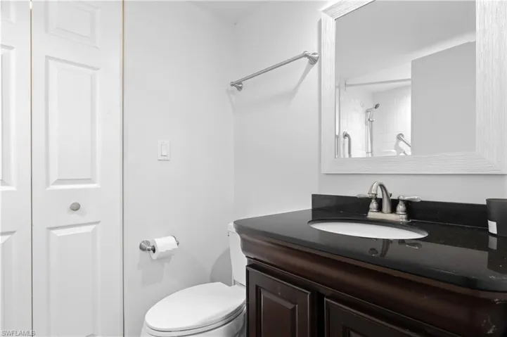 Bathroom with vanity, a closet, and a shower