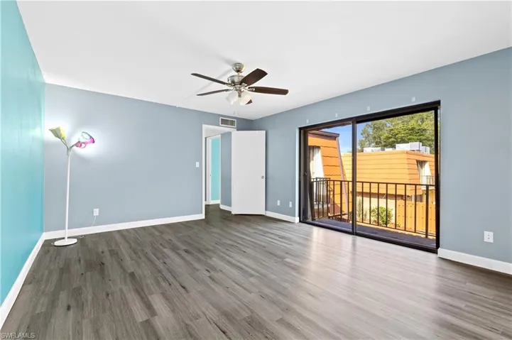 Unfurnished living room with wood finished floors and ceiling fan