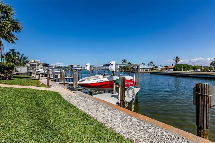 Dock area featuring a water view and a yard