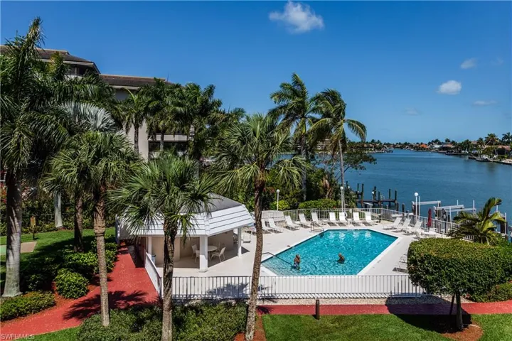 View of pool with a patio area and a water view