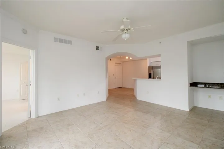 Spare room featuring crown molding and ceiling fan