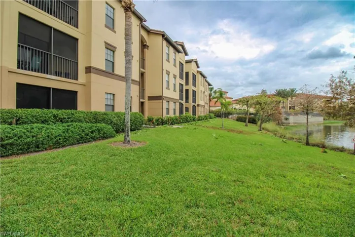 View of community featuring a lawn and a water view