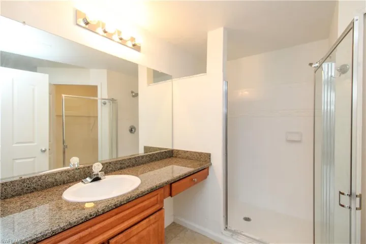 Bathroom with vanity and a shower with shower door