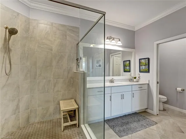 Walk-in shower with full-height tile surround and glass enclosure