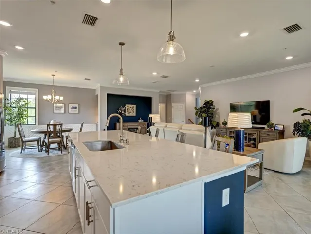 Expansive kitchen island featuring a light-toned countertop and an undermount sink