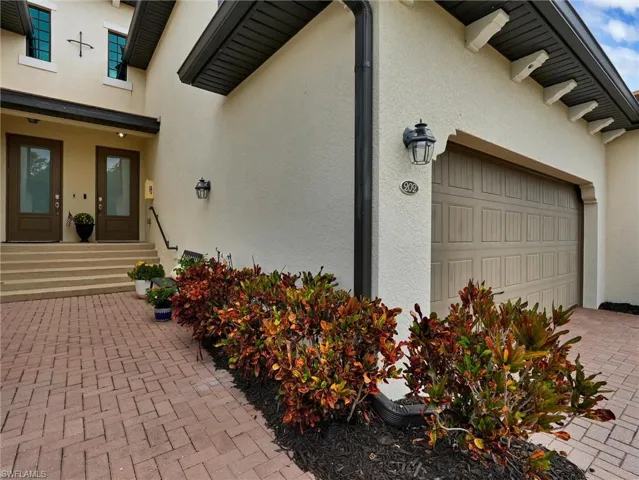 Stucco exterior with a paver driveway