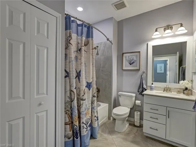 Contemporary bathroom featuring a white vanity with a light-colored countertop, an undermount sink, and brushed nickel fixtures