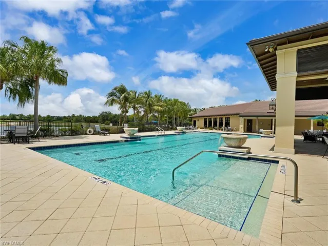 Resort-style pool with integrated spa and decorative water features