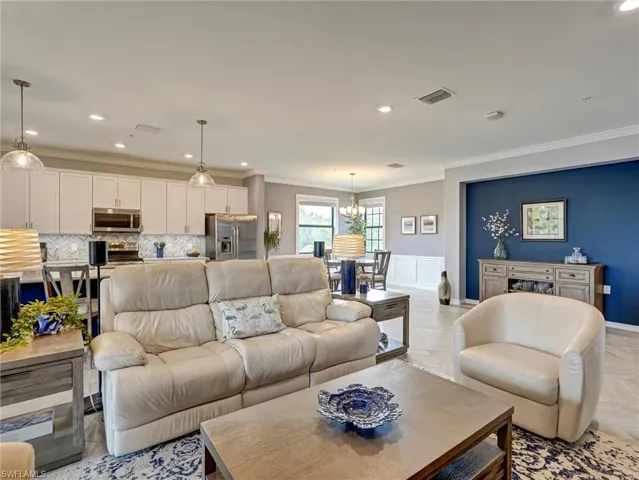 Open-concept living space featuring recessed lighting, pendant fixtures, and tile flooring