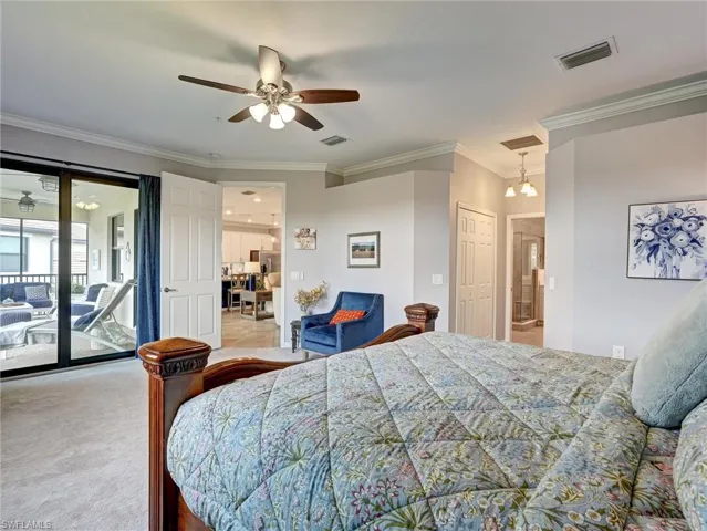 Carpeted interior space featuring a ceiling fan with integrated lighting, crown molding, and direct access to an outdoor screened lanai through sliding glass doors