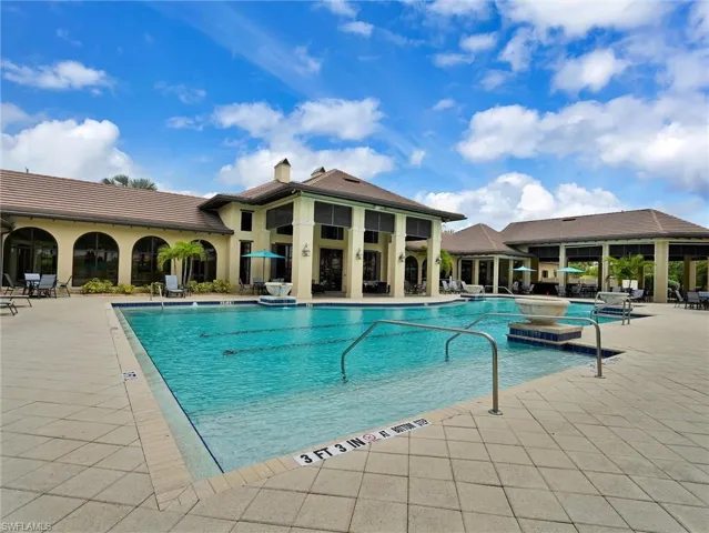 Resort-style swimming pool featuring lane markers and integrated handrails
