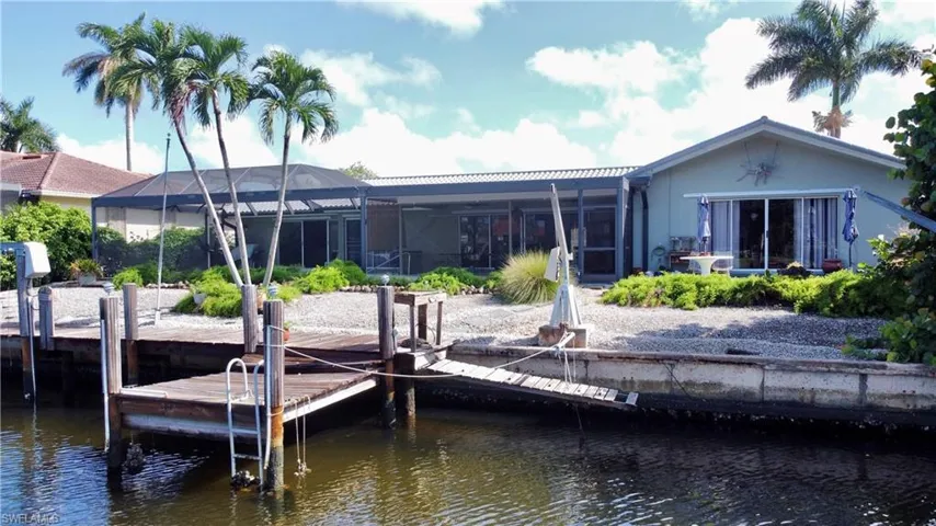 Dock area with a lanai and a water view