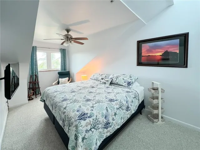 Carpeted bedroom with ceiling fan