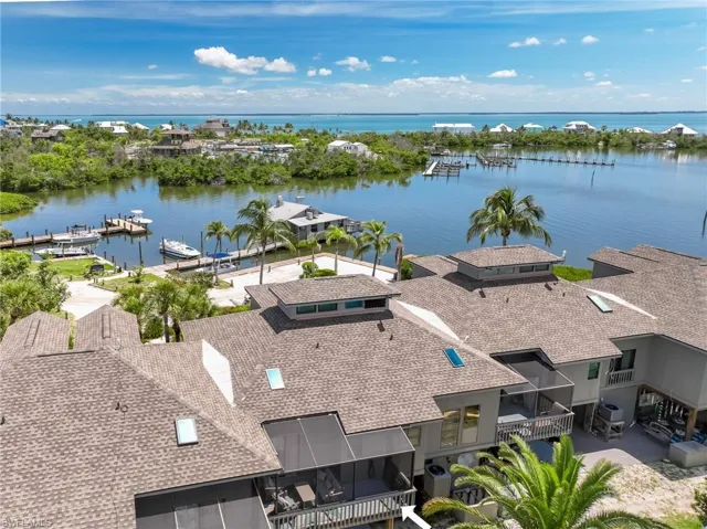 Birds eye view of property with a water view